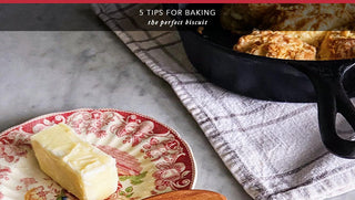 Freshly baked biscuits on a rustic wooden table, with a set of tips for achieving the perfect texture and flavor every time.