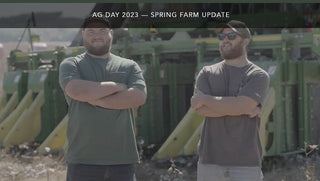 Farmers inspecting cotton plants on Ag Day 2023, showcasing Red Land Cotton’s commitment to sustainable farming practices.