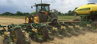 Farmers on the Red Land Cotton farm preparing for the spring season, with cotton fields ready to be tended and cultivated.